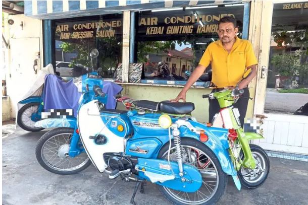 A barber keeps vintage motorcycles on the road